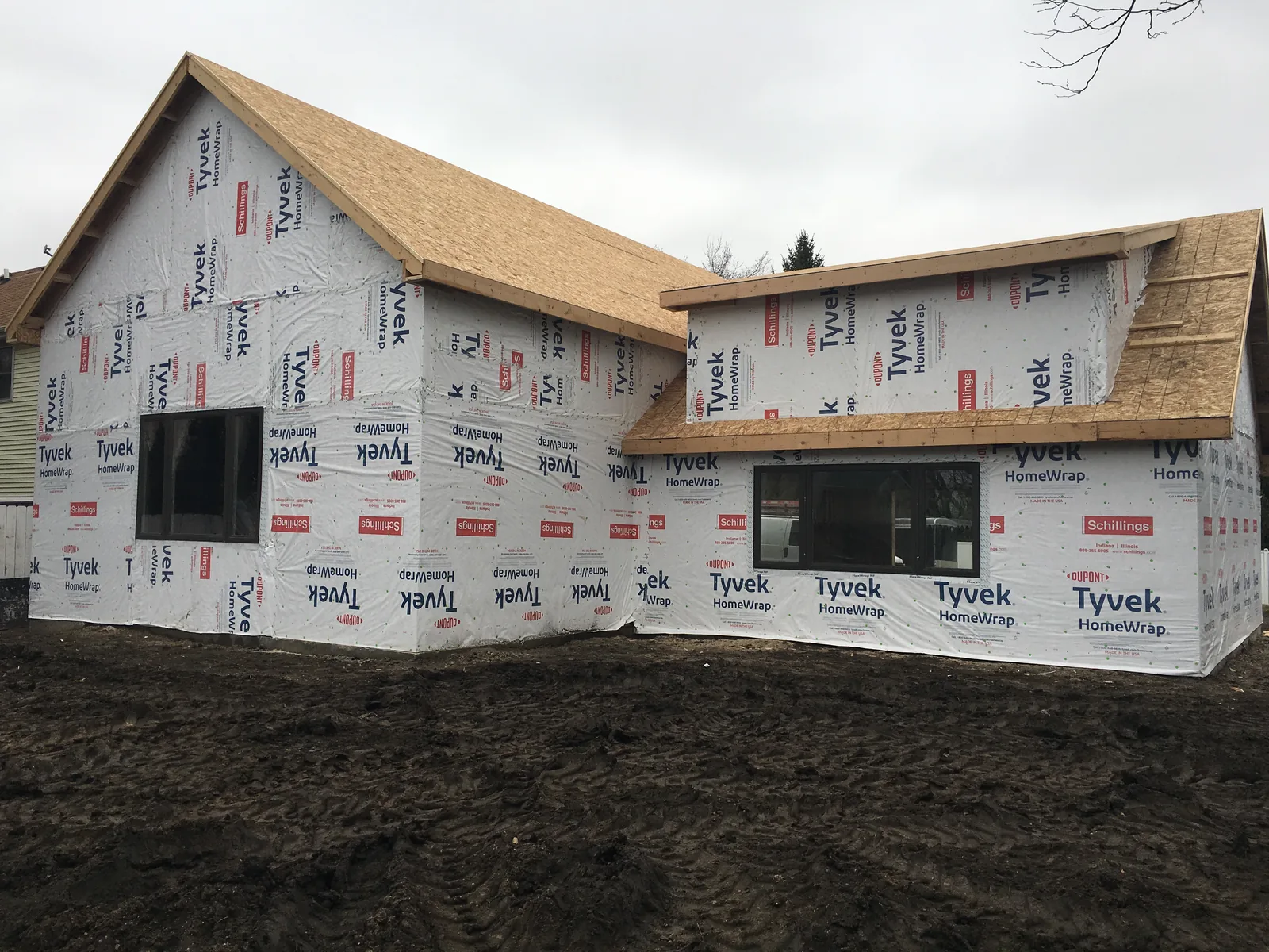 New home framed and wrapped in house wrap during construction by EZ Custom Homes